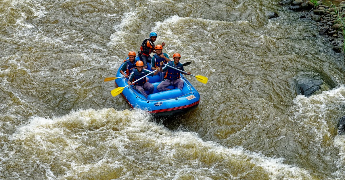 Group of adults rafting in Cikidang, West Java, showcasing teamwork on rough waters.