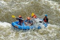 Adventurous group rafting through rapids in Cikidang, West Java, Indonesia.